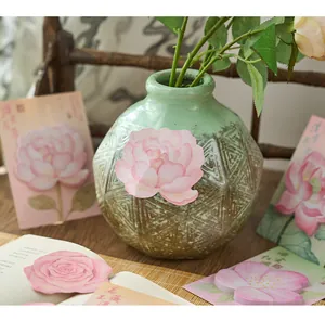 Detailed view of flower-shaped sticky notes featuring elegant Chinese floral designs.