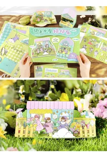 Nahaufnahme des zusammengebauten DIY-Papierpuppenhauses mit Garten- und Feenillustrationen