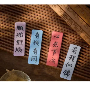 Detailed view of Chinese calligraphy epoxy fridge magnets with blessings on bamboo background