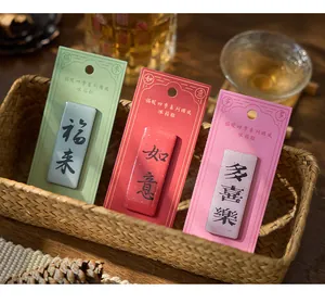 Detailed macro view of Guofeng blessing text fridge magnets in red, green and pink in a basket