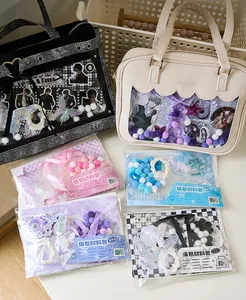 Detailed view of DIY ita-bag decoration kits with ribbons, pom-poms, and lace
