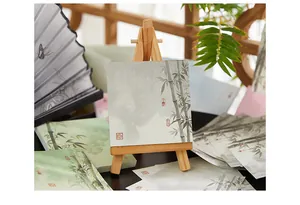 Close-up of Chinese style sticky notes with bamboo ink-wash design on a wooden easel