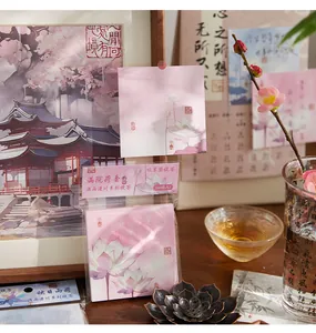 Close-up of classical Chinese style sticky notes with elegant pink lotus floral patterns.