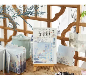 Close-up of elegant Chinese style lotus memo pads displayed on a mini wooden easel