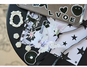 Close-up of DIY Ita-bag material kit with iridescent butterfly wings and black stickers