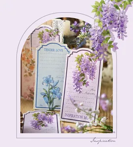 Close-up of vintage floral stationery tags with purple wisteria and lily illustrations