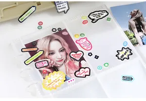 Close-up of colorful English phrase stickers on a transparent photocard binder