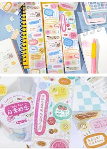 Close-up of decorative die-cut washi tape with colorful illustrations and text for scrapbooking.