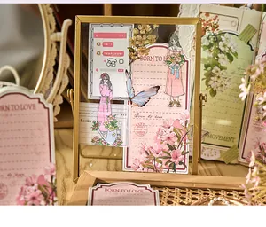 Artistic floral stationery stickers displayed in a gold picture frame for journaling.