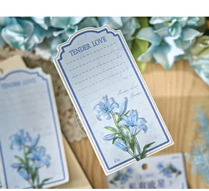 Close-up of floral illustration memo card with blue lilies and Tender Love text
