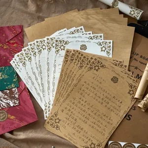 Vintage gilded stationery set with embossed floral borders and marble textured envelopes.