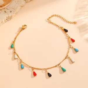 Macro view of 18K gold plated chain bracelet adorned with colorful enamel teardrop charms.