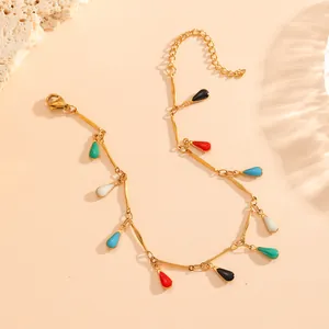 Detailed macro shot of 18K gold-plated bracelet featuring vibrant teardrop charms.