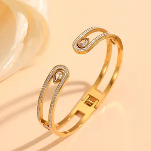 Close-up of gold stainless steel geometric bracelet with micro paved rhinestones