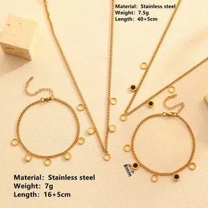 Detail view of gold stainless steel necklace and bracelet set with shell circle charms
