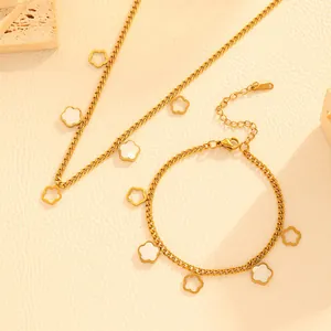 Detail view of gold-plated stainless steel necklace and bracelet set with flower charms