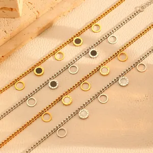 Macro detail of stainless steel jewelry chains with shell and Roman numeral charms
