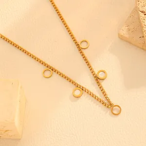 Detail view of 18k gold plated necklace with hollow and white shell circular charms