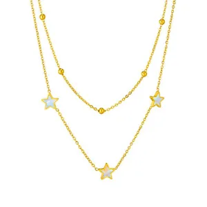 Macro view of 18K gold plated double layered star necklace with white shell inlays