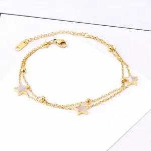 Detailed view of a double-layered 18K gold stainless steel bracelet with star charms.