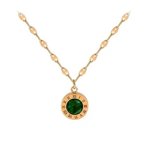 Detail of rose gold stainless steel necklace with green gem pendant and Roman numerals