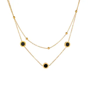 Detail view of a double-layered gold stainless steel necklace with Roman numerals