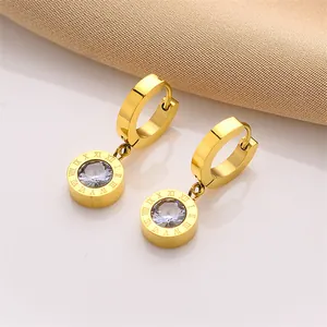 Detailed view of gold stainless steel hoop earrings with Roman numeral drop pendants