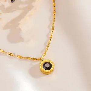 Gold-plated stainless steel necklace detail featuring a Roman numeral pendant with black stone.
