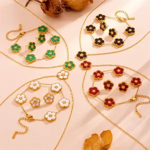Macro view showing multiple clover jewelry sets in green, red, black, and white colors