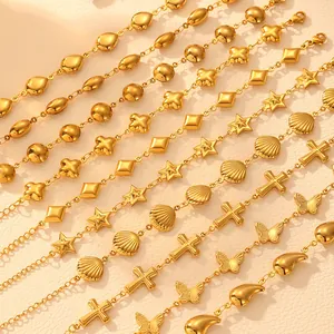Detailed view of titanium steel gold bracelets with star, shell, and cross charms