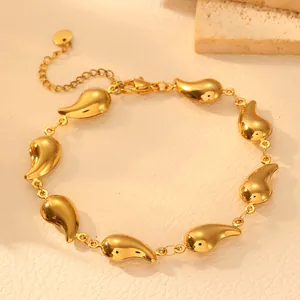 Detail view of a gold-plated stainless steel bracelet featuring sleek teardrop links