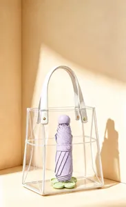 Floral umbrella stand base shown holding a purple folding umbrella inside a clear tote bag