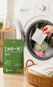 Detail showing a laundry color absorber sheet being held near a front-load washing machine