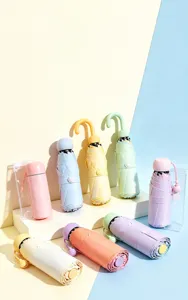 Creative colorful support caps for folding umbrellas in various pastel shades