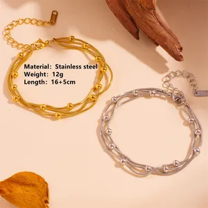 Close-up of three-layer stainless steel bead bracelet in gold and silver finish.