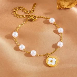Elegant gold stainless steel pearl bracelet featuring a white four-leaf clover charm for women