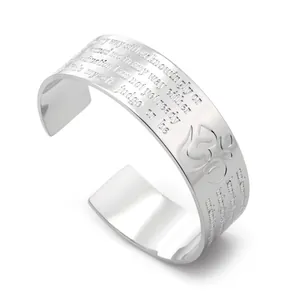 Close-up detail of silver titanium steel cuff bracelet featuring engraved motivational text