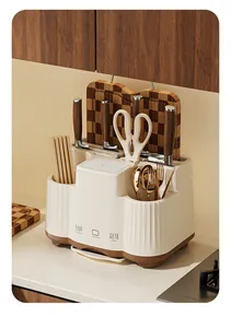 Macro view of cream integrated kitchen organizer holding wooden knives and golden cutlery