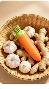Karottenförmiges 3-in-1-Ingwer-Knoblauch-Werkzeug im Weidenkorb mit frischen Zutaten