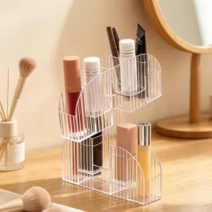 Clear acrylic desktop organizer for lipstick and cosmetics on a wooden vanity table.