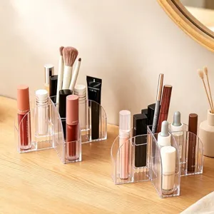 Transparent acrylic desktop makeup organizer with tiered compartments for brushes and lipsticks