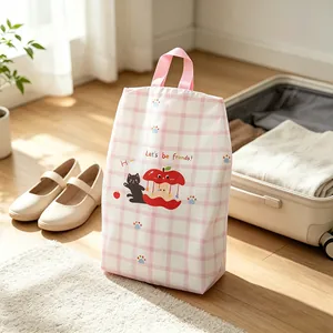 Detailed view of the pink plaid travel shoe storage bag featuring cute cat and apple motifs