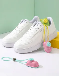 Close-up detail of pink and green capsule shoe deodorizers inside white sneakers