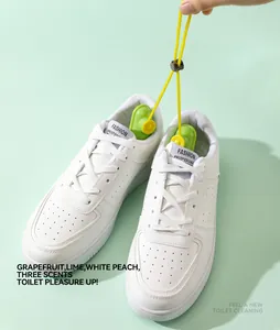 Detail view of scented shoe deodorizer balls placed inside white sneakers.