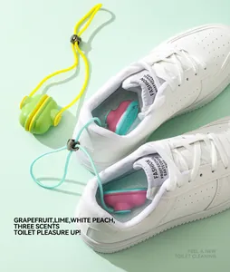 Detail view of colorful shoe deodorizer balls inside white sneakers for odor removal
