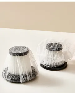 Detailed close-up of disposable non-woven protective mesh sleeves on vacuum filters
