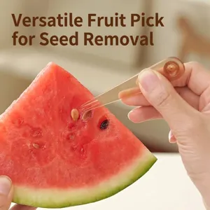 Versatile brown fruit fork being used to pick seeds from a fresh watermelon slice.