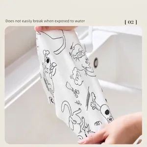 Durable disposable kitchen cleaning cloth with cat print being stretched to show strength