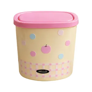 Mini desktop trash can with flip-top lid and cute pastel polka dot pattern