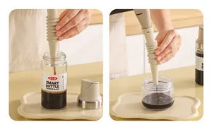Detailed view of cream-colored detachable kitchen funnel pouring liquid into jars